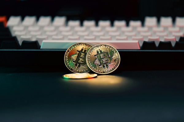 Bitcoin coins in front of a keyboard