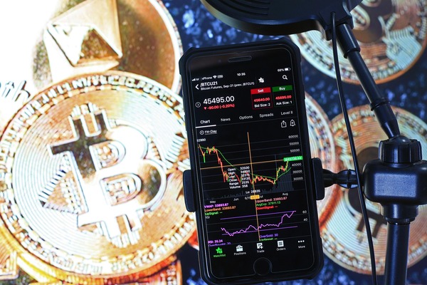 Bitcoin coins with a smartphone showing a chart