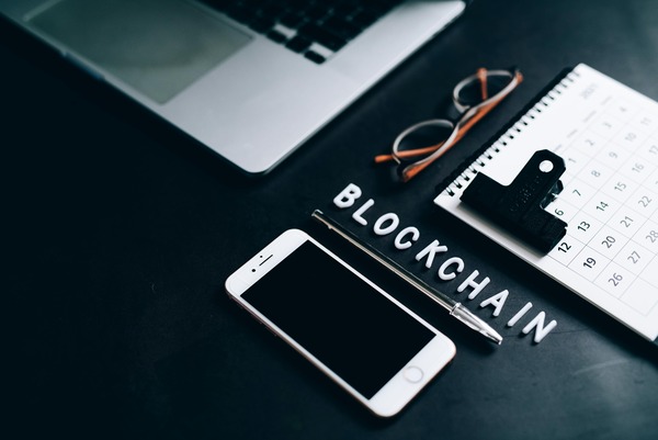 Blockchain tiles with a smartphone and notebook