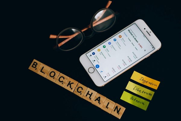 Blockchain tiles with a smartphone showing a crypto app