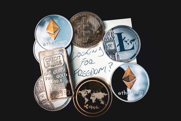Crypto coins with a silver bar and a handwritten note