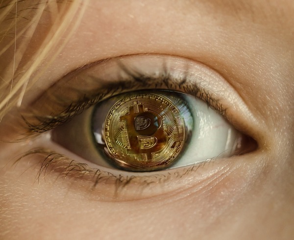 Eye reflecting a Bitcoin coin