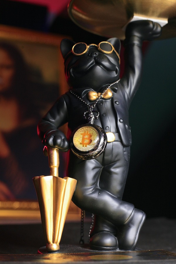 Figurine holding a Bitcoin coin