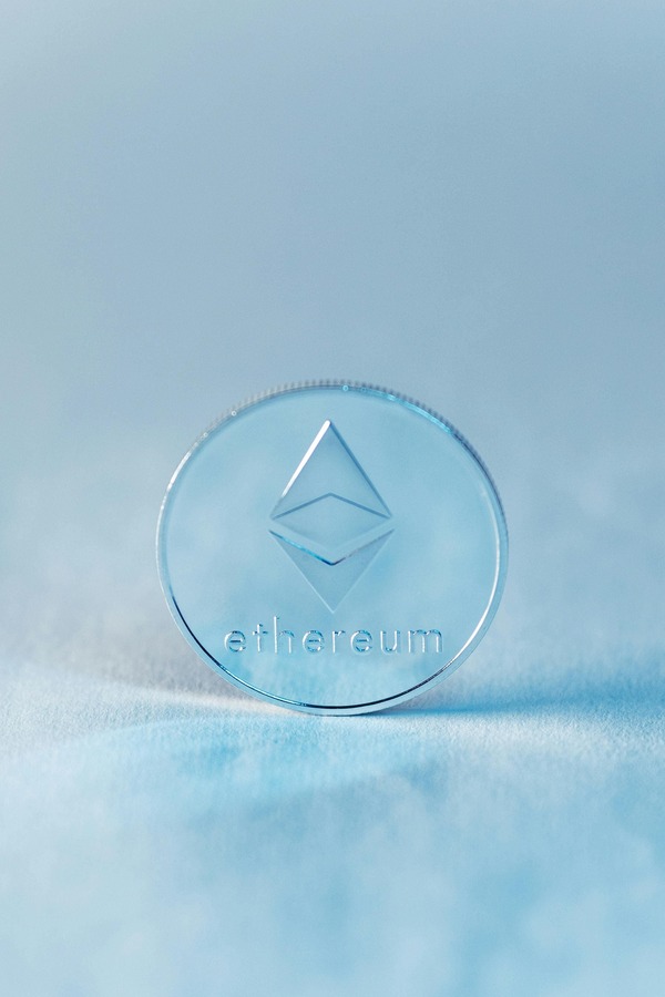 Glass Ethereum coin on a light blue background
