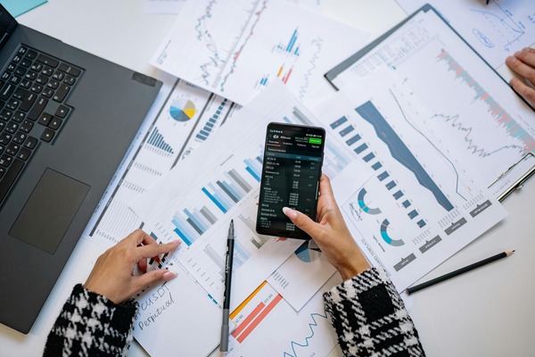 Person reviewing financial charts with a smartphone