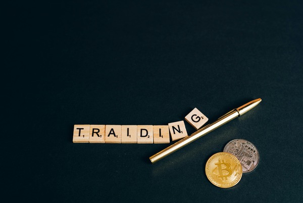 Trading letter tiles with a pen and coin