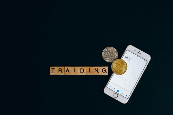 Trading letter tiles with a smartphone and Bitcoin coin